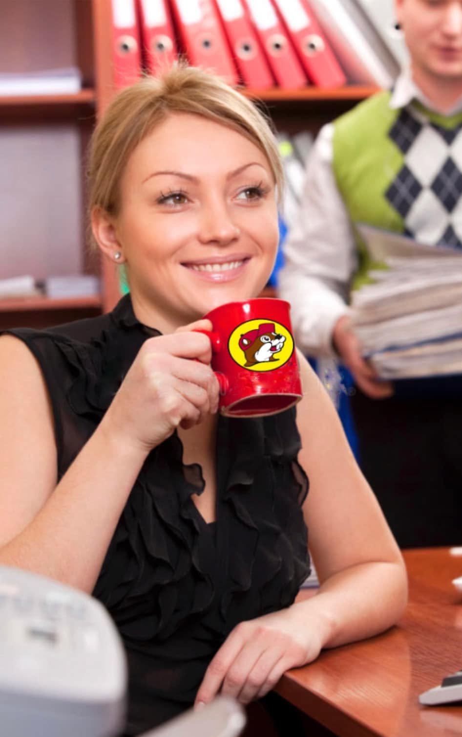 An office employee holds a Buc-ee's branded mug amid the ongoing ethics investigation